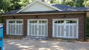 a new residential carriage house garage door being installed in Hickory North Carolina
