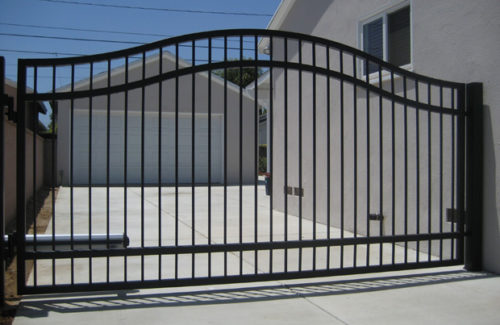 single swinging wrought iron residential security gate outside a home in Lenoir