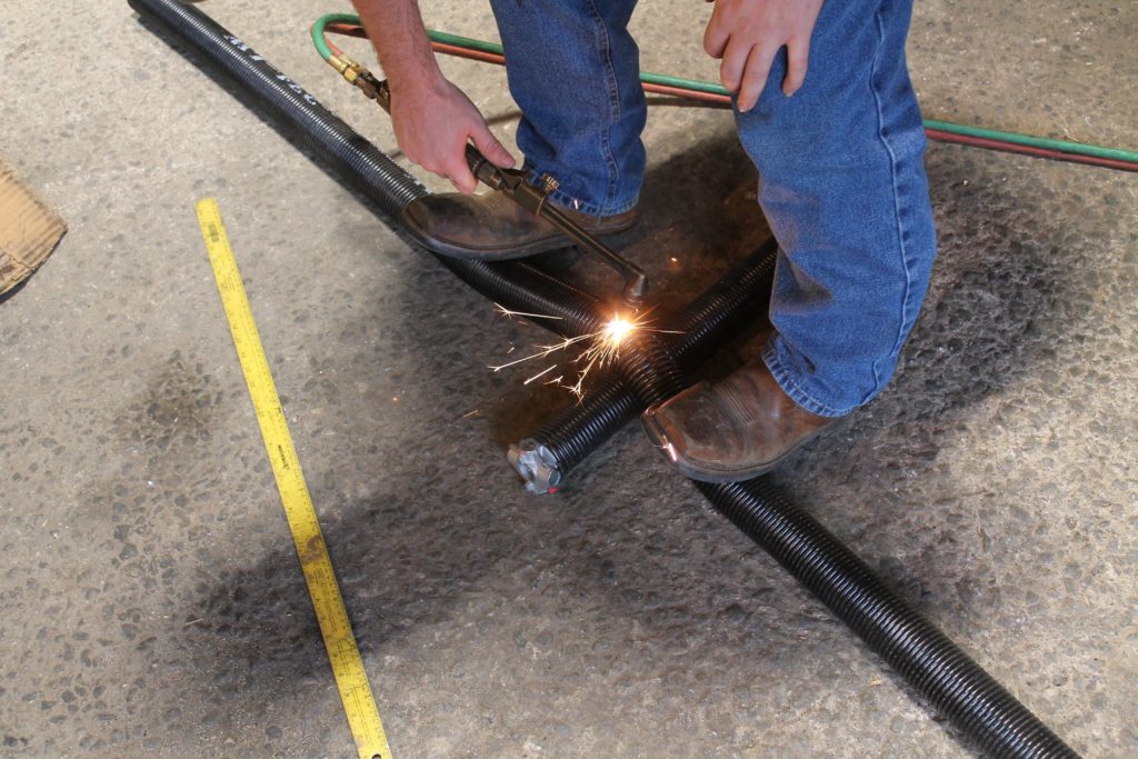 a residential garage door torsion spring being replaced in Statesville NC
