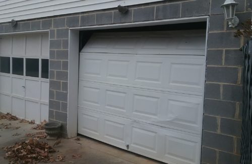 a broken garage door before garage door specialists repaired it